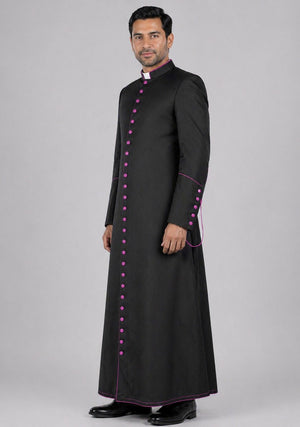 Man wearing a black robe with pink buttons on a gray background