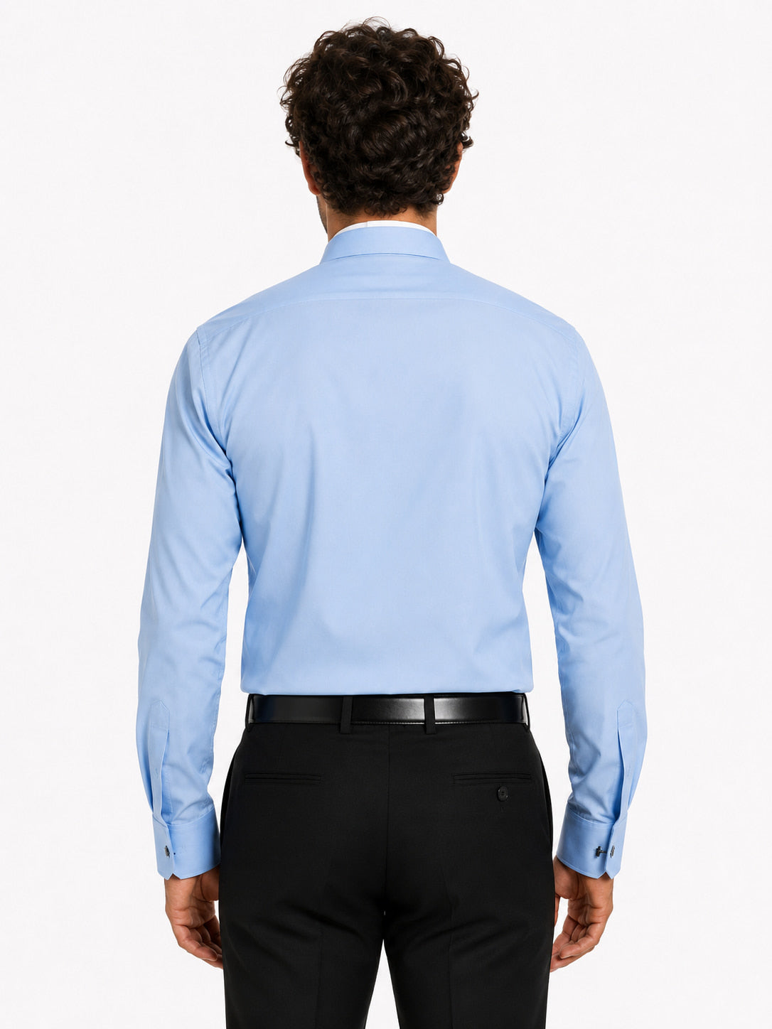 Man wearing a light blue clerical shirt and black pants on a white background
