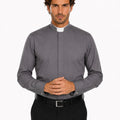 Man wearing a gray clerical shirt with a white collar on a white background