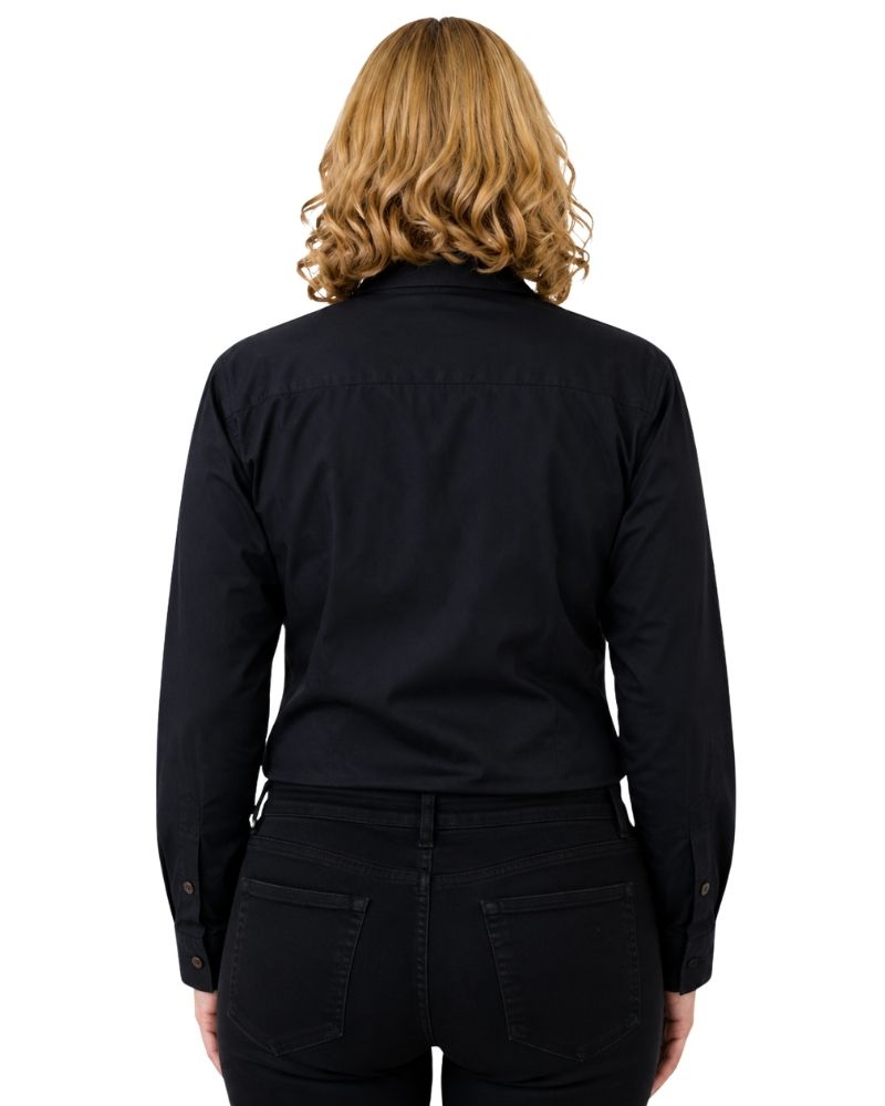 A woman viewed from the back wearing a black long-sleeve button-up shirt and black pants against a plain white background.