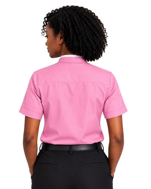 A woman shown from the back wearing a short-sleeve pink clerical shirt tucked into black trousers with a black belt, against a plain white background.