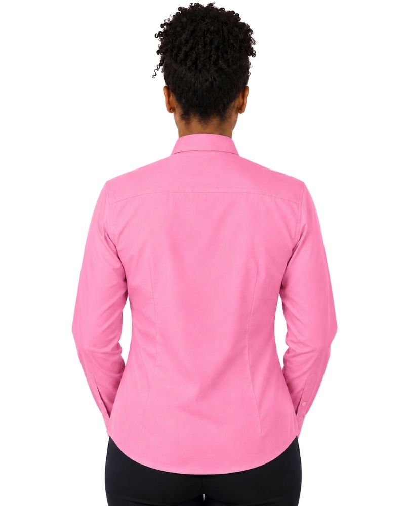 A woman viewed from the back wearing a bright pink long-sleeve clerical shirt and black pants, set against a plain white background.