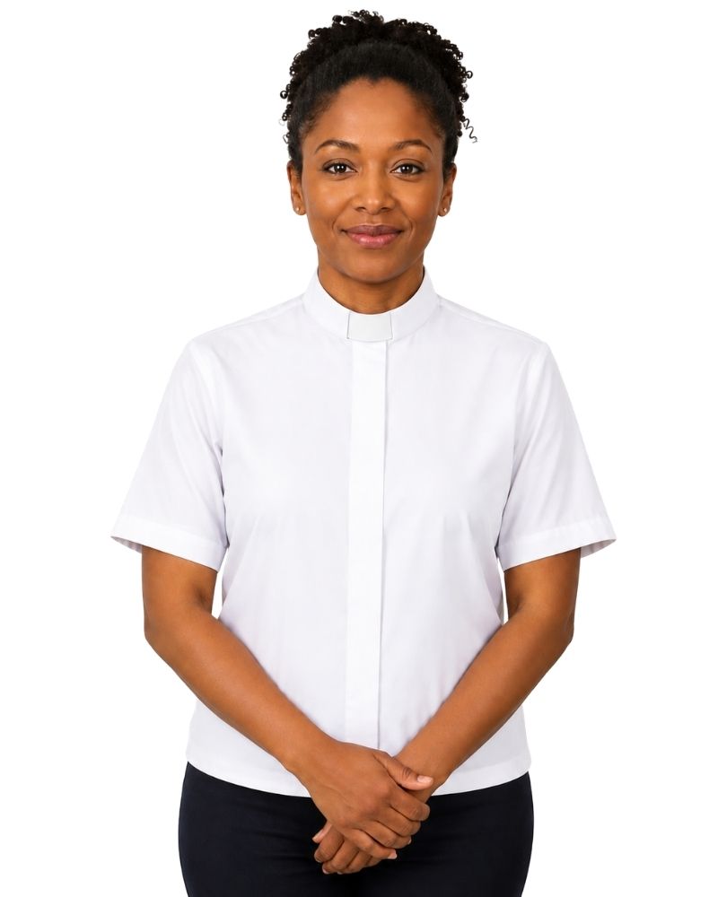 A woman wearing a white short-sleeve clerical shirt with a collar, paired with black trousers, standing against a solid white background.