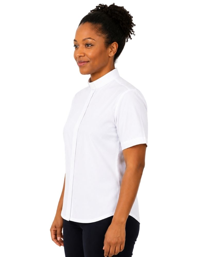 A woman wearing a white short-sleeve button-up shirt with a mock neck, paired with black pants, shown from a side profile against a plain white background.
