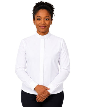A woman wearing a white long-sleeve clerical shirt with a vertical placket, paired with black pants, standing against a plain white background.