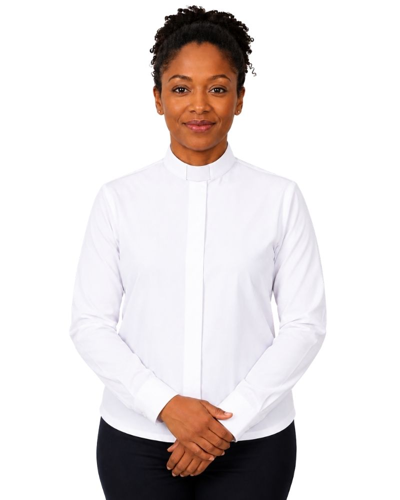 A woman wearing a white long-sleeve clerical shirt with a vertical placket, paired with black pants, standing against a plain white background.