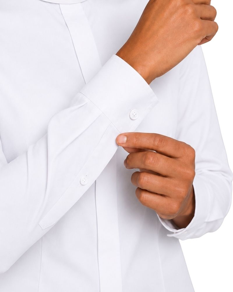 close up of the cuffs women wearing clerical shirt on plain white background.