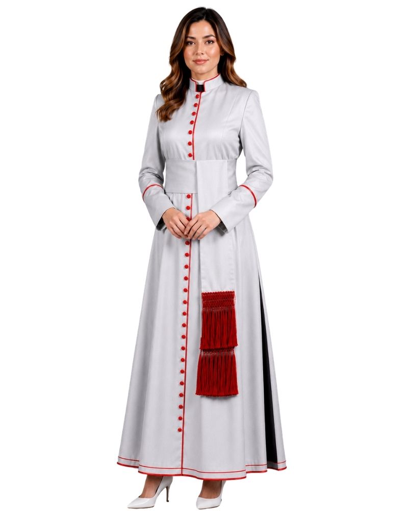 A woman modeling a long white cassock with red button details, red piping, and a red tassel accent, set against a plain white background.