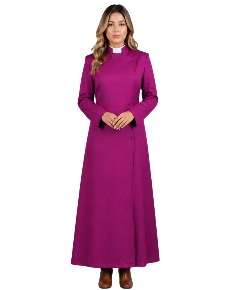 A woman modeling a long magenta-purple cassock with a white collar, standing against a plain white background.