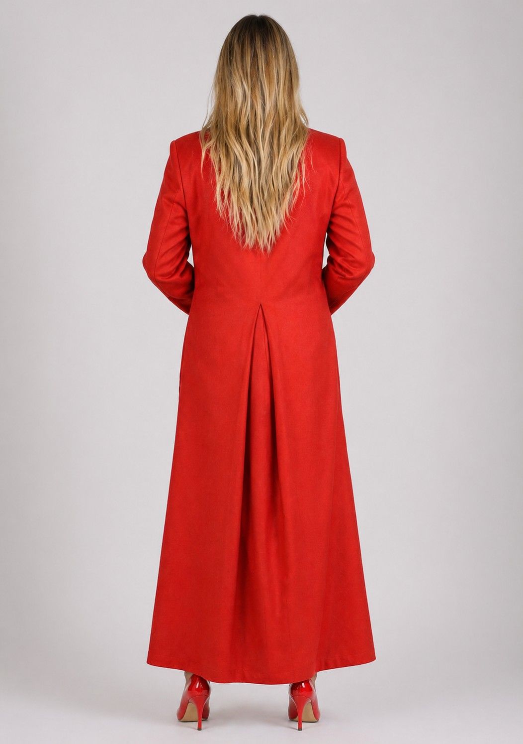 Women wearing a long red coat from behind on a white background