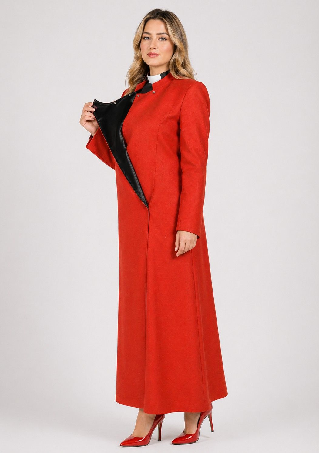Woman wearing a red dress with black accents on a white background