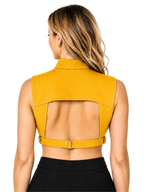 A woman shown from the back wearing a mustard yellow sleeveless clergy dickey and a wide adjustable waist belt, paired with black bottoms, against a plain white background.