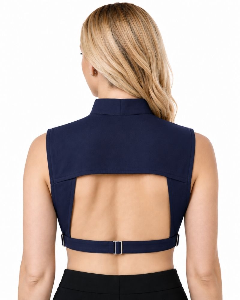 A woman shown from the back wearing a sleeveless navy blue clergy dickey and a wide open back, featuring a thin strap with a small silver buckle at the waist.