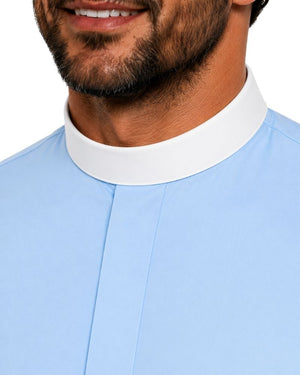 Close-up of a man wearing a light blue clerical shirt with a contrasting white high stand-up collar, shown against a plain white background.