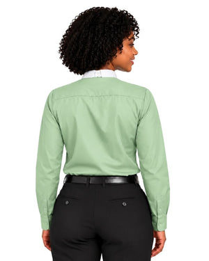 A woman shown from the back wearing a sage green long-sleeve clerical shirt tucked into black pants, against a plain white background.