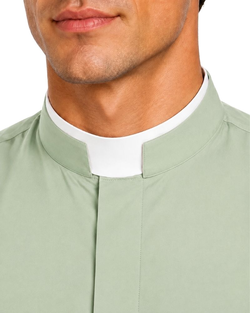 Close-up of a man wearing a sage green clerical collar shirt with a white clerical collar insert, shown from the chest up against a white background.