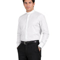 Man wearing a white dress shirt and black pants on a white background