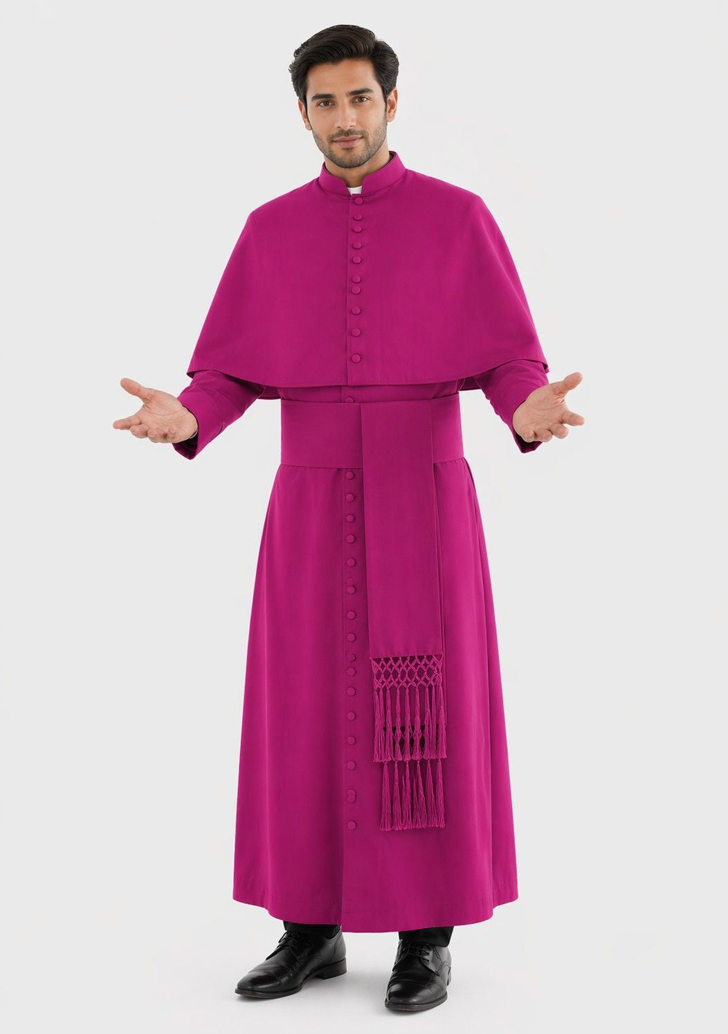Man wearing a magenta religious robe with a white background