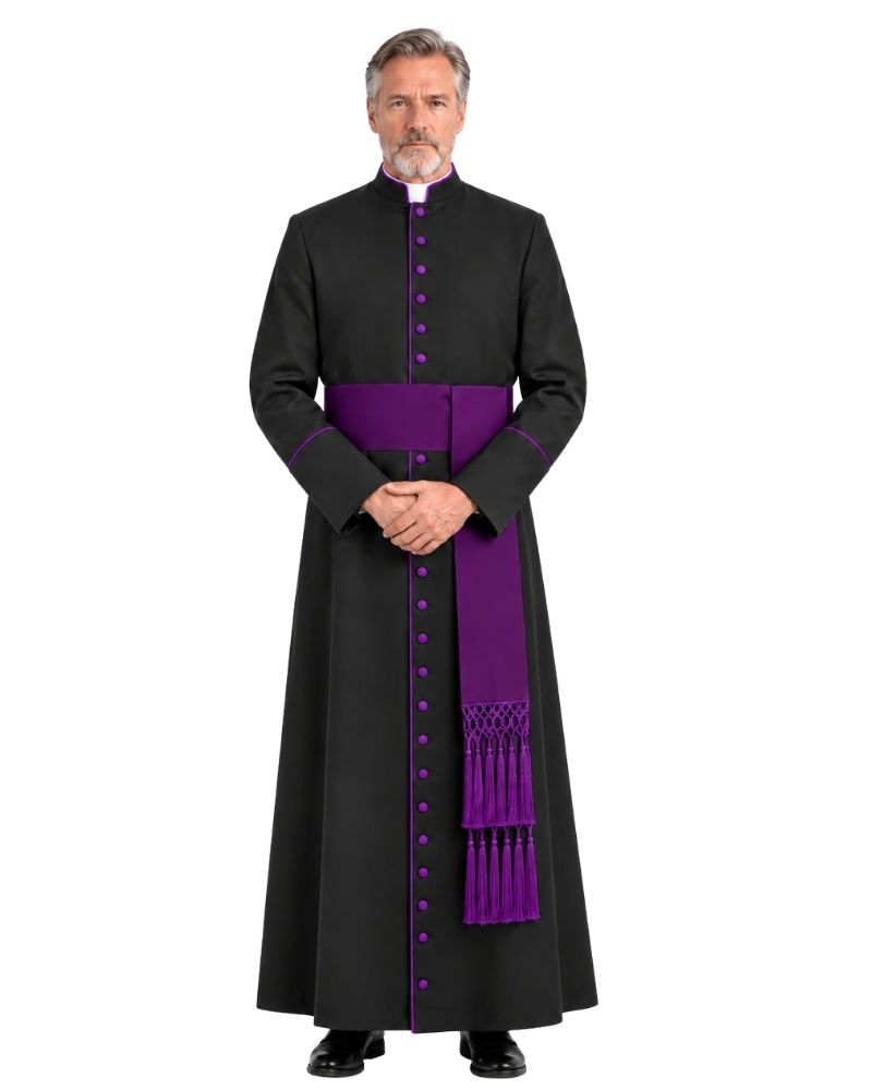 A man wearing Black Clergy Robe With Roman Purple Accents with a purple sash and matching purple buttons, standing against a plain white background.