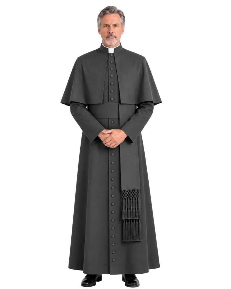 A man modeling a Black Ethan Cassock with Shoulder Cape with a high collar, front buttons, and a decorative tassel detail near the lower front, photographed against a plain white background.