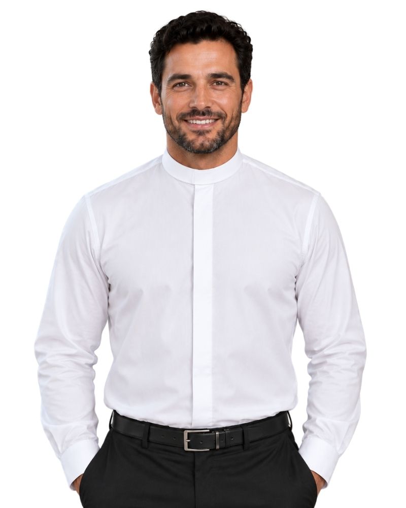 A smiling man wearing a white long-sleeve clerical shirt with a high mock neck collar, paired with black trousers and a black belt, against a plain white background.