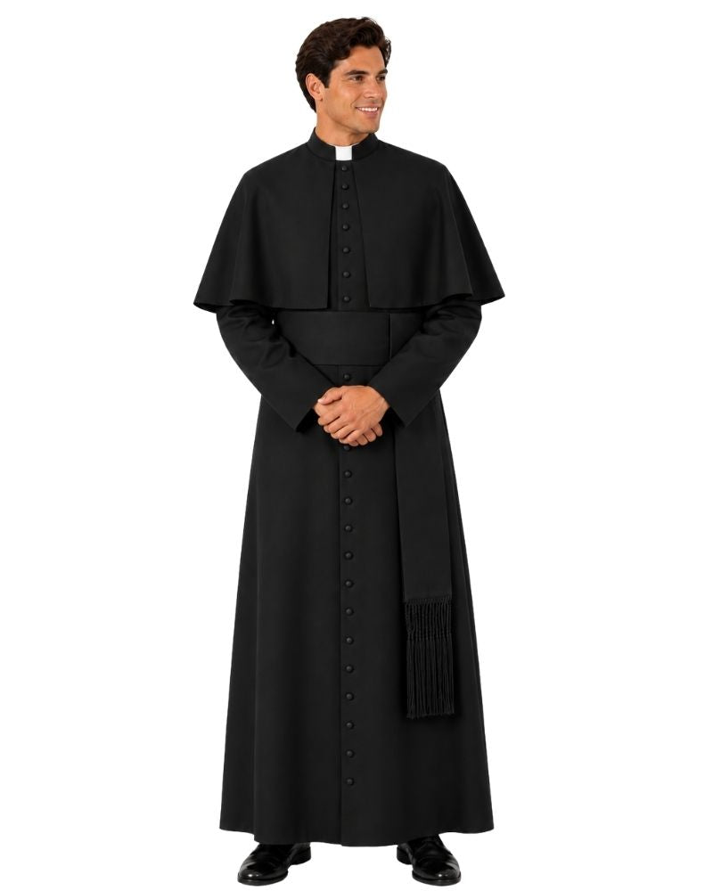A man modeling a black priestly cassock with a high collar, front buttons, and a draped capelet, standing against a plain white background.