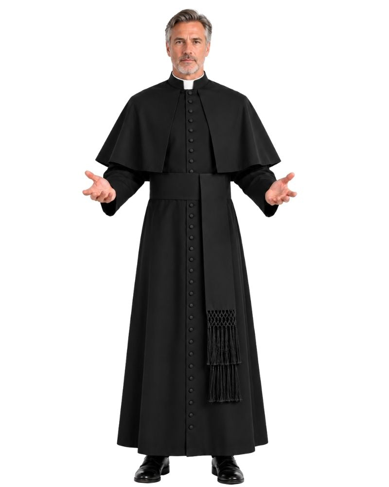 A man modeling a black priest cassock with a long robe, matching cape, and a white collar, set against a plain white background.