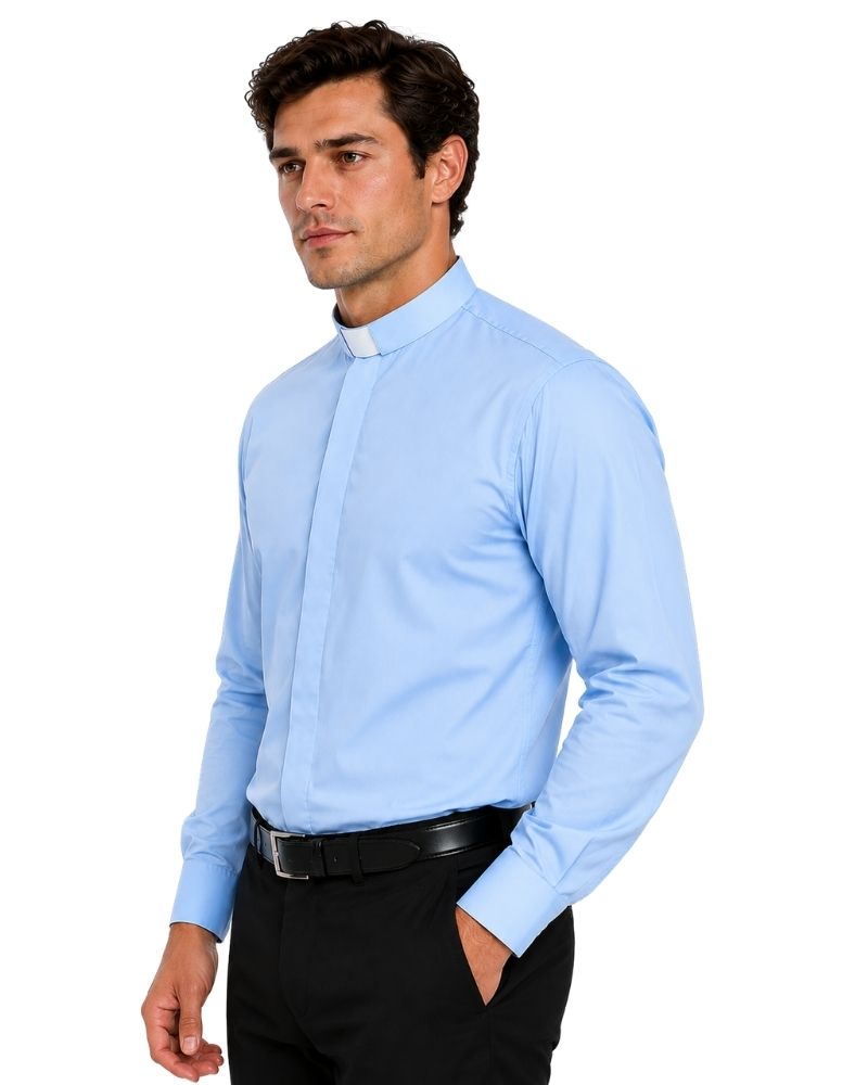 A man wearing a light blue long-sleeve clerical shirt with a clerical collar, paired with black trousers and a black belt, photographed against a solid white background.