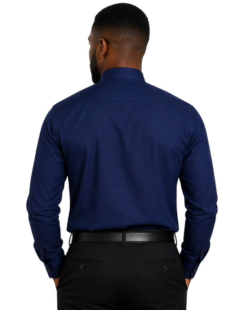 A man viewed from the back wearing a navy blue long-sleeve clerical shirt tucked into black trousers with a black belt, against a plain white background.