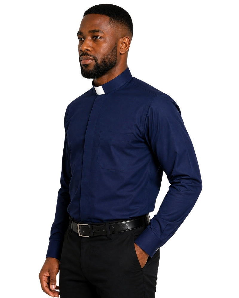 A man wearing a navy blue long-sleeve clerical shirt with a white clerical collar, paired with black trousers and a black belt, shown against a plain white background.