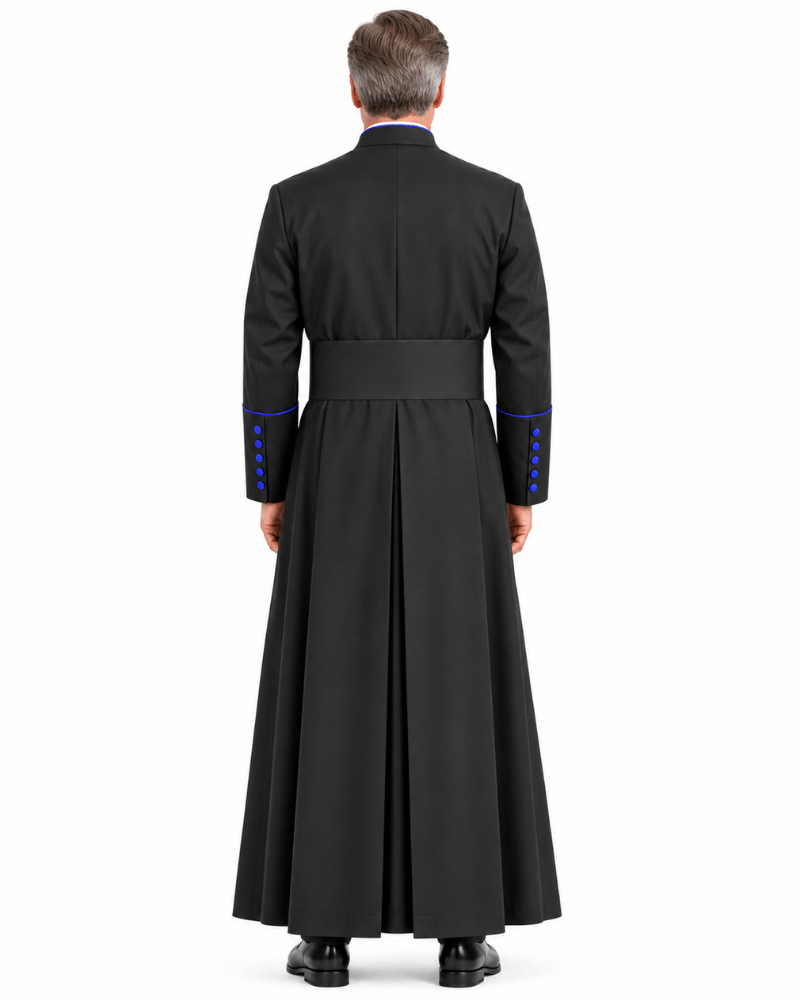 A man viewed from the back wearing Obsidian Royal Blue Clerical Cassock with a waist belt and blue button accents on the sleeves, against a plain white studio background.