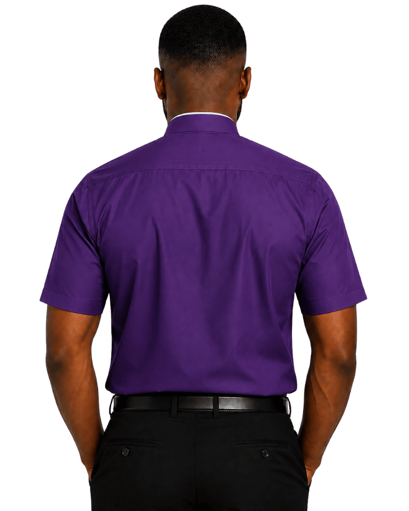 A man viewed from the back wearing a purple short-sleeve clerical shirt tucked into black trousers, set against a plain white background.