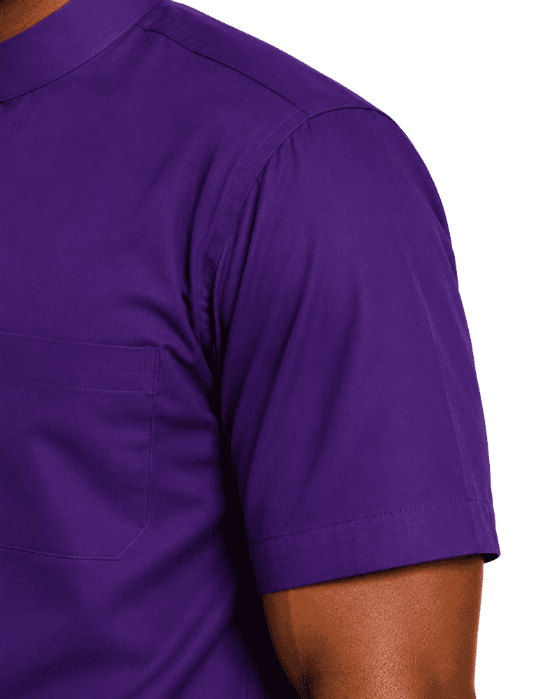 Close-up of a man wearing a solid purple short-sleeve clerical shirt with a chest pocket, shown against a plain white background.