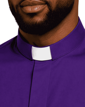 A close-up of a man wearing a purple clerical shirt with a white collar tab, cropped from the lower face to the chest against a plain white background.