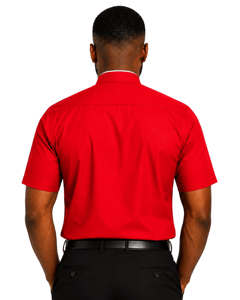A man viewed from the back wearing a bright red short-sleeve clerical shirt and black trousers against a plain white background.