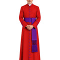 A man wearing a Red Clergy Robe With Purple Trim with a high collar, front buttons, and a cape like shoulder drape, standing against a plain white background.