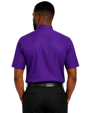 A man viewed from the back wearing a short-sleeve purple clerical shirt and black trousers against a plain white background.