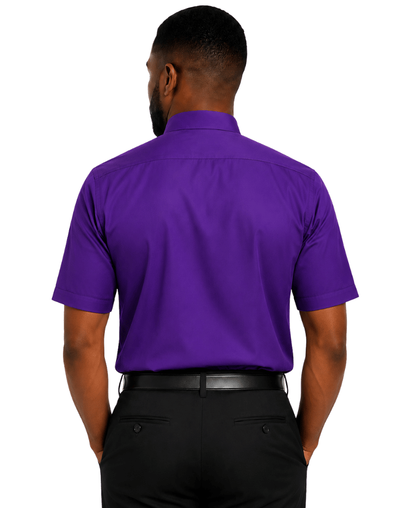 A man viewed from the back wearing a short-sleeve purple clerical shirt and black trousers against a plain white background.