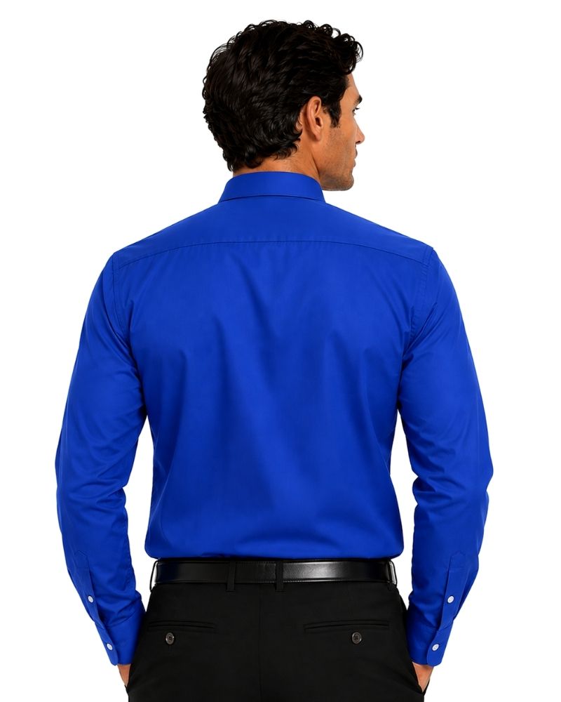 A man viewed from the back wearing a bright royal blue long-sleeve clerical shirt and black trousers against a plain white background.