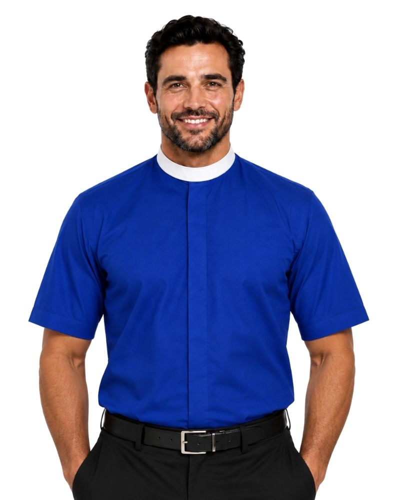 A smiling man wearing a royal blue short-sleeve clerical shirt with a white collar, paired with black trousers and a black belt, against a plain white background.