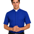 A man wearing a royal blue short-sleeve clerical shirt with a white collar, paired with black trousers and a black belt, against a plain white background.