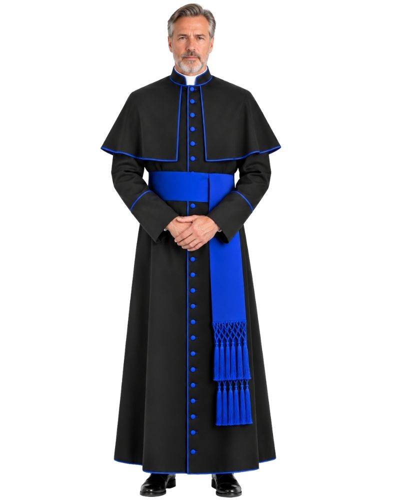 A man modeling a Traditional Clerical Cassock With Blue Trim, a matching blue sash, and blue decorative buttons, set against a plain white background.