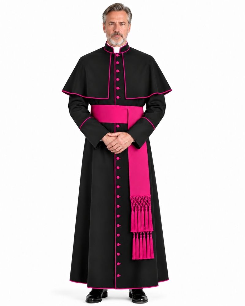 A man modeling a Traditional Clerical Cassock With Magenta Trim with vibrant pink trim, a pink waist sash, and a pink dalmatic, set against a plain white background.