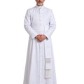 A man wearing a White Clergy Cassock with a high collar, front buttons, a waist belt, and a decorative white sash with fringe, standing against a plain white background.