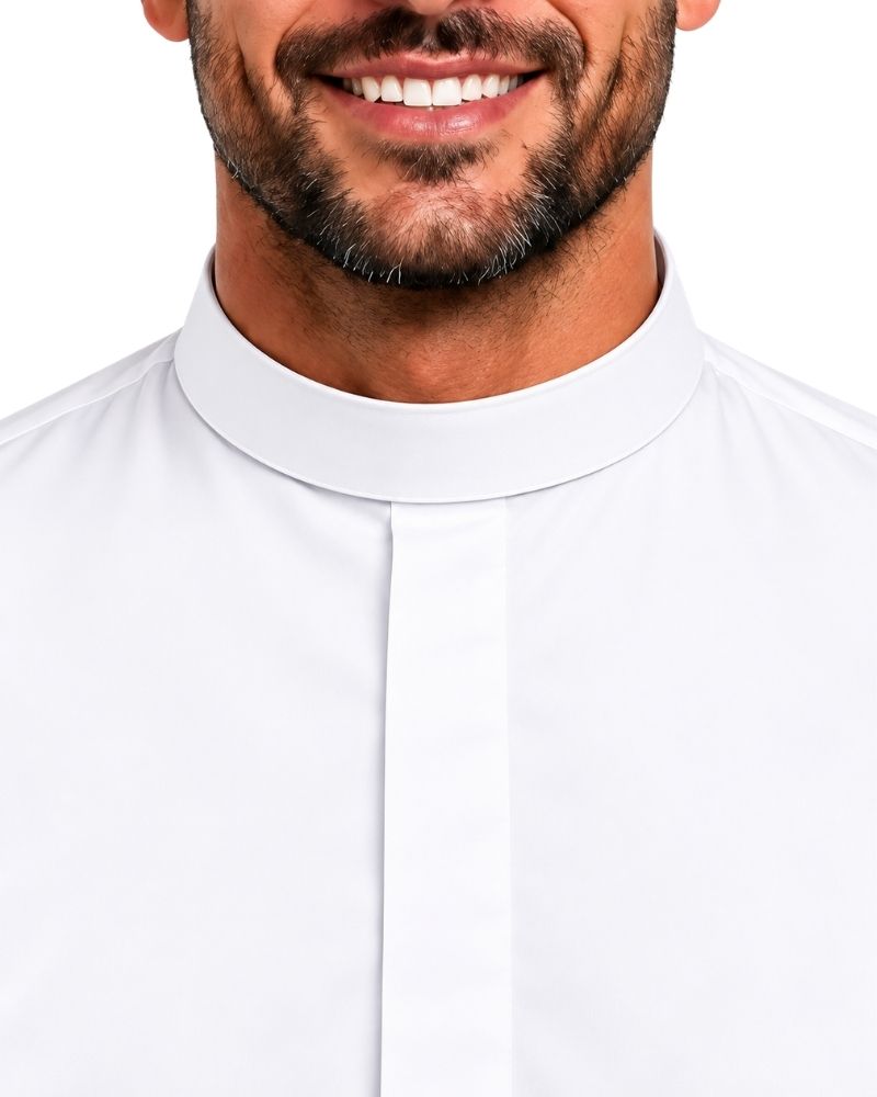 Close-up of a man wearing a white clerical collar shirt with a high stand-up collar and front placket, shown against a plain white background.