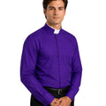 Man wearing a purple shirt with a clerical collar against a white background