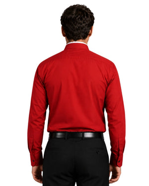 Man wearing red clerical shit with roman collar on white background.