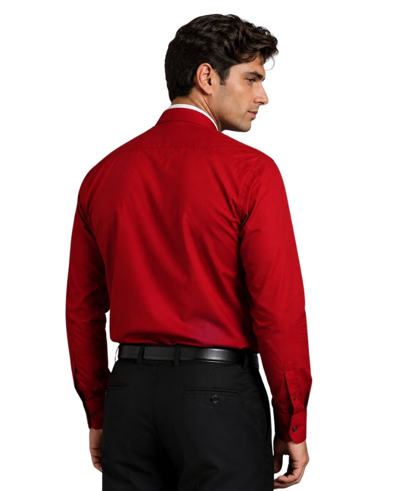 Man wearing red clerical shit with roman collar on white background.