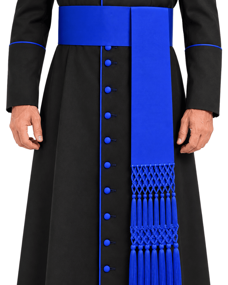 A closeup of the man wearing Black Clerical Cassock With Royal Blue Trim against the white plain background.