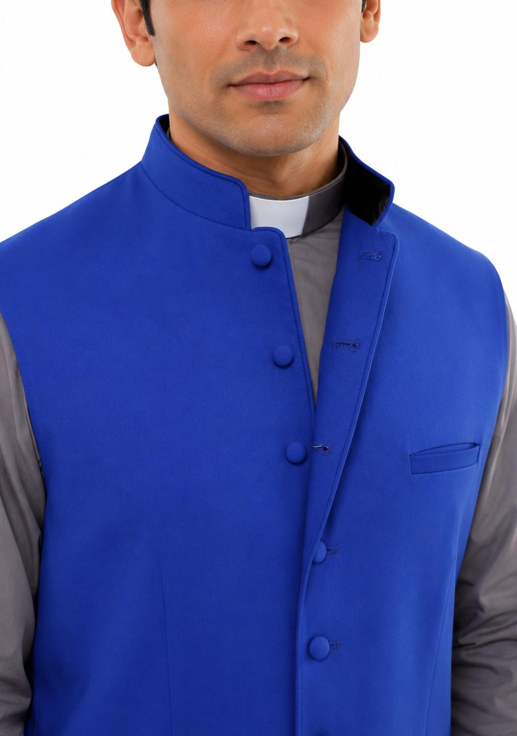  Man wearing a blue vest over a gray shirt on a white background